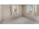 A bedroom featuring carpet, painted walls, and two windows at 2753 N High School Rd, Indianapolis, IN 46224