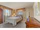 Cozy bedroom featuring a bed with floral bedding and wooden furniture at 2753 N High School Rd, Indianapolis, IN 46224