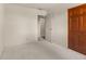 A bedroom featuring carpet, painted walls, and a wood closet door at 2753 N High School Rd, Indianapolis, IN 46224