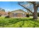 Charming brick home with a manicured lawn, mature trees, and shuttered windows, offering great curb appeal at 2753 N High School Rd, Indianapolis, IN 46224