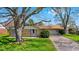Charming single-story brick home with mature tree, green lawn, and driveway leading to attached garage at 2753 N High School Rd, Indianapolis, IN 46224
