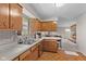 A kitchen features wooden cabinets, stainless steel sink, and brick backsplash at 2753 N High School Rd, Indianapolis, IN 46224