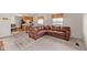 Comfortable living room with an overstuffed leather sofa, connecting to the kitchen area at 2753 N High School Rd, Indianapolis, IN 46224