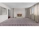Bright living room features a classic fireplace with white brick surround and neutral carpeting at 2753 N High School Rd, Indianapolis, IN 46224