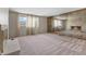 Spacious living room featuring a mirrored fireplace, neutral carpet, and bright natural light at 2753 N High School Rd, Indianapolis, IN 46224