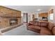 Open-concept living room and kitchen area featuring a stone fireplace and comfortable seating at 2753 N High School Rd, Indianapolis, IN 46224