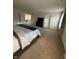 Large carpeted bedroom with a view of an adjacent sitting area and a TV on a stand at 280 Walker Dr, Whiteland, IN 46184