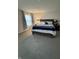Spacious bedroom featuring carpet floors, a king-sized bed with plush bedding, and natural light at 280 Walker Dr, Whiteland, IN 46184