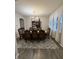Formal dining room with elegant wood table, chairs, decorative rug, and natural light from large window at 280 Walker Dr, Whiteland, IN 46184
