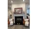 Living area featuring a fireplace, comfortable seating, and decorative mantle at 280 Walker Dr, Whiteland, IN 46184