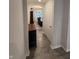 Hallway shot leading to dining area with wood flooring and a view to a bright and inviting dining room at 280 Walker Dr, Whiteland, IN 46184