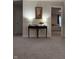 Hallway featuring a decorative table with lamps and art, leading to doorways and a glimpse of a bedroom at 280 Walker Dr, Whiteland, IN 46184