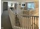 Bright hallway featuring carpet floors, white railing, and an open floor plan with views of the living room at 280 Walker Dr, Whiteland, IN 46184