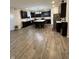 Open-concept kitchen boasts dark cabinets, a large island, modern appliances, and ample counter space at 280 Walker Dr, Whiteland, IN 46184