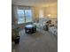 Cozy upstairs living room with large window, comfortable seating, and natural light, offering a relaxing space at 280 Walker Dr, Whiteland, IN 46184