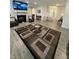 Cozy living area featuring a fireplace, comfortable seating, and open access to other rooms at 280 Walker Dr, Whiteland, IN 46184