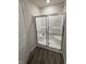 Modern shower stall featuring glass doors, a built-in seat, and sleek fixtures in a bright bathroom at 280 Walker Dr, Whiteland, IN 46184