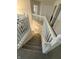 View of well-lit staircase with white railing and carpeted steps at 280 Walker Dr, Whiteland, IN 46184