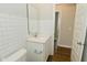 Bathroom featuring white subway tile, granite countertop and wood-look floor at 321 Bluestem Ln, Whiteland, IN 46184
