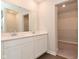 A modern bathroom offers a double sink vanity with a large mirror and a walk-in closet for ample storage at 321 Bluestem Ln, Whiteland, IN 46184