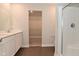 This bathroom features a double vanity, a spacious walk-in closet, and a modern glass shower, offering luxury at 321 Bluestem Ln, Whiteland, IN 46184