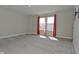 A bedroom with neutral carpet, gray walls, and windows with red patterned curtains at 321 Bluestem Ln, Whiteland, IN 46184