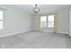 The bedroom is carpeted with white trim, natural light, and modern light fixture at 321 Bluestem Ln, Whiteland, IN 46184