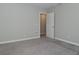 A carpeted bedroom featuring neutral walls and an open closet for easy storage and access at 321 Bluestem Ln, Whiteland, IN 46184