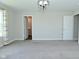 A spacious bedroom features neutral walls, carpet, and a modern light fixture, creating a serene retreat at 321 Bluestem Ln, Whiteland, IN 46184