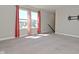 A bedroom with neutral carpet, gray walls, and windows with red patterned curtains at 321 Bluestem Ln, Whiteland, IN 46184
