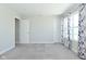 Bedroom featuring neutral carpet, gray walls, with 2 doors and window at 321 Bluestem Ln, Whiteland, IN 46184
