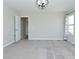 A bright bedroom features neutral walls, carpet, and a modern light fixture, creating a serene retreat at 321 Bluestem Ln, Whiteland, IN 46184