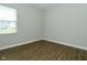 Well-lit bedroom with luxury vinyl plank flooring and a view to the neighborhood at 321 Bluestem Ln, Whiteland, IN 46184