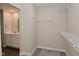 This well-organized walk-in closet offers wire shelving and convenient access to the adjoining bathroom at 321 Bluestem Ln, Whiteland, IN 46184