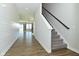 Open entryway with stairs, shiplap accent wall, and view into a spacious living area at 321 Bluestem Ln, Whiteland, IN 46184