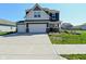 Two story home with a three car garage and a well manicured lawn at 321 Bluestem Ln, Whiteland, IN 46184