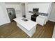 Modern kitchen with white cabinets, stainless steel appliances, and large center island at 321 Bluestem Ln, Whiteland, IN 46184
