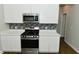 Close up of modern kitchen features, stainless steel oven, mosaic tile backsplash, and white countertops at 321 Bluestem Ln, Whiteland, IN 46184