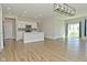 Open-concept living space with bar seating, stainless steel appliances, and sliding glass doors at 321 Bluestem Ln, Whiteland, IN 46184