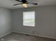 Cozy bedroom boasts new carpet, neutral paint, ceiling fan and natural light from a window at 3333 Lupine Dr, Indianapolis, IN 46224