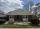 Charming single-story brick home with a black fence and well-maintained front yard on a sunny day at 3333 Lupine Dr, Indianapolis, IN 46224