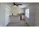 Cozy kitchen with white cabinets, appliances, bar seating area and new carpeting in the combined living space at 3333 Lupine Dr, Indianapolis, IN 46224