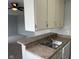 Kitchen bar area with cabinets, sink, countertop and dishwasher, which is open to another room in the house at 3333 Lupine Dr, Indianapolis, IN 46224