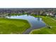Aerial view showcases a neighborhood with a lake and golf course at 3634 W 58Th St, Indianapolis, IN 46228