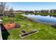 Backyard showcases a large wooden deck with seating, view of lake, and garden at 3634 W 58Th St, Indianapolis, IN 46228