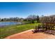 Enjoy a peaceful backyard view with a wooden deck and serene lake, perfect for relaxation at 3634 W 58Th St, Indianapolis, IN 46228