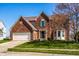 Charming two-story brick home with a well-maintained front yard and attached two-car garage at 3634 W 58Th St, Indianapolis, IN 46228