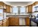 Well-lit kitchen boasts granite countertops, wood cabinets, and stainless steel appliances at 3634 W 58Th St, Indianapolis, IN 46228