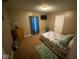 This bedroom features a cozy bed, with blue accents and includes a wood dresser, all illuminated by a ceiling light at 3818 Graceland Ave, Indianapolis, IN 46208