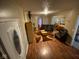 Inviting living room featuring hardwood floors, comfortable leather seating, and an open view into the adjacent dining area at 3818 Graceland Ave, Indianapolis, IN 46208